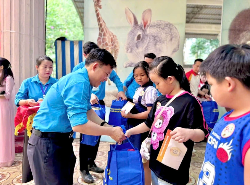 Ông Phùng Thái Quang, Phó Chủ tịch LĐLĐ TP.HCM trao quà cho con em đoàn viên, người lao động.