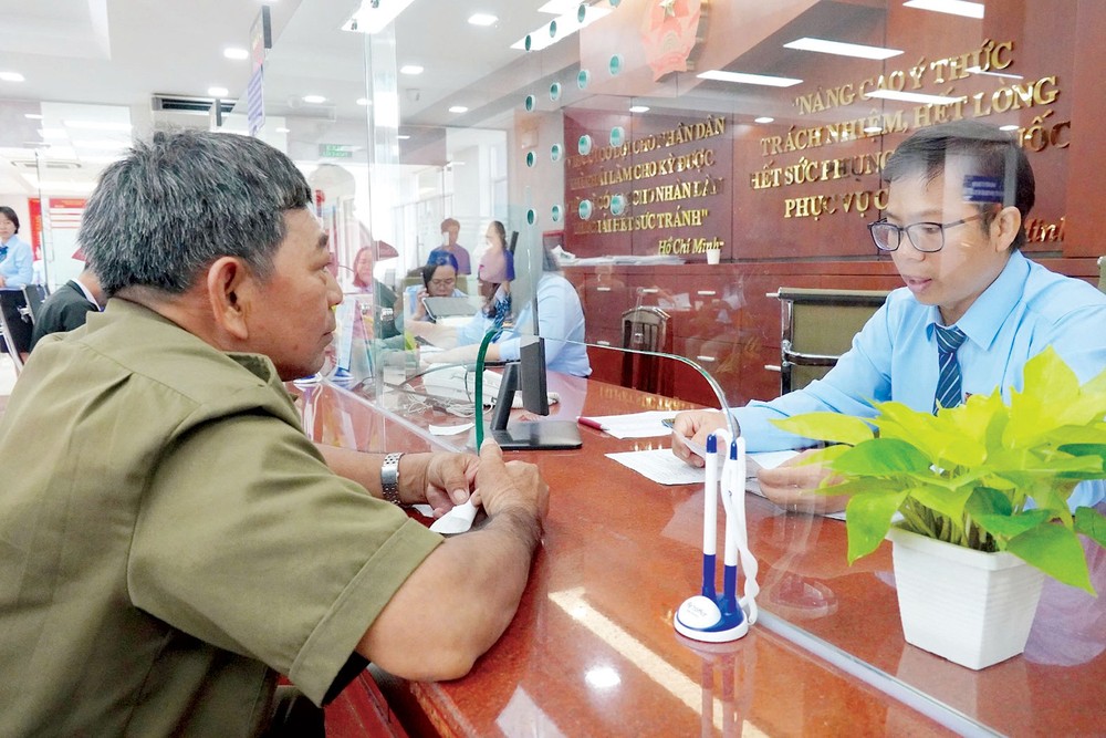 Công chức phường Tân Mỹ (TPHCM) tiếp và giải quyết thủ tục cho người dân X2c.jpg