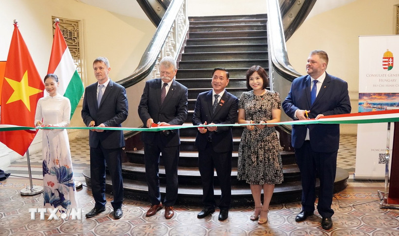 Đại biểu hai nước Việt Nam và Hungary thực hiện nghi thức cắt băng khai mạc triển lãm ảnh. (Ảnh: Trung Tuyến/TTXVN)